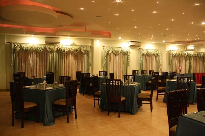 Multi-cuisine restaurant with starlit ceiling and draped windows