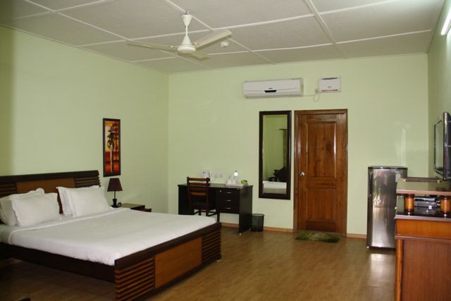Executive Room with king-size bed, work desk and warm wooden furnishings